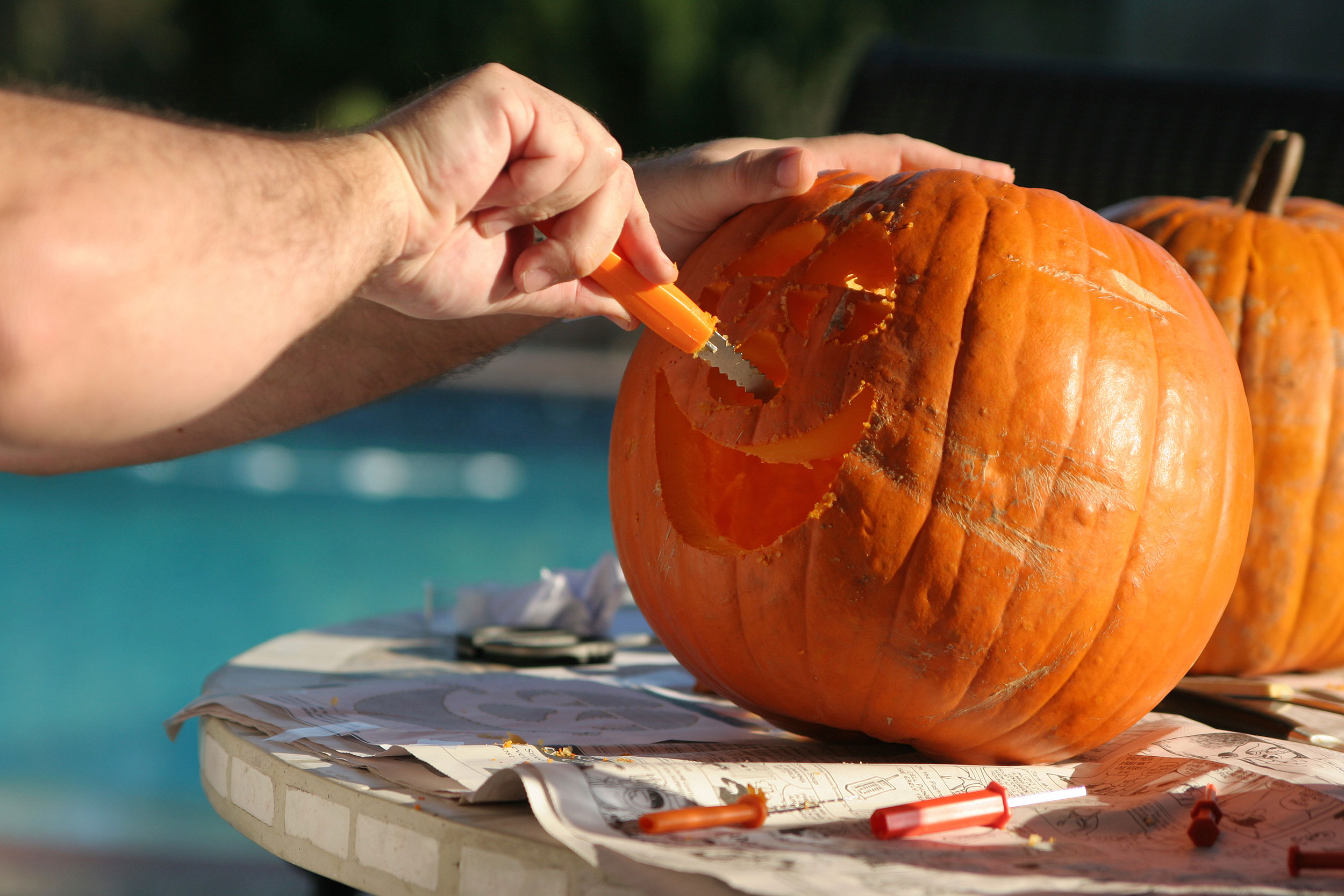 A carved jack-o’-lantern glowing on a porch at night